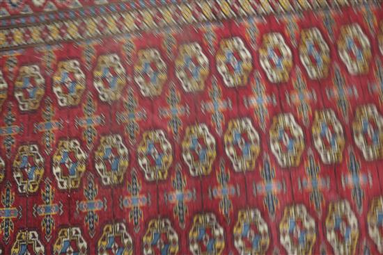 A Bokhara design red ground runner 340 x 97cm